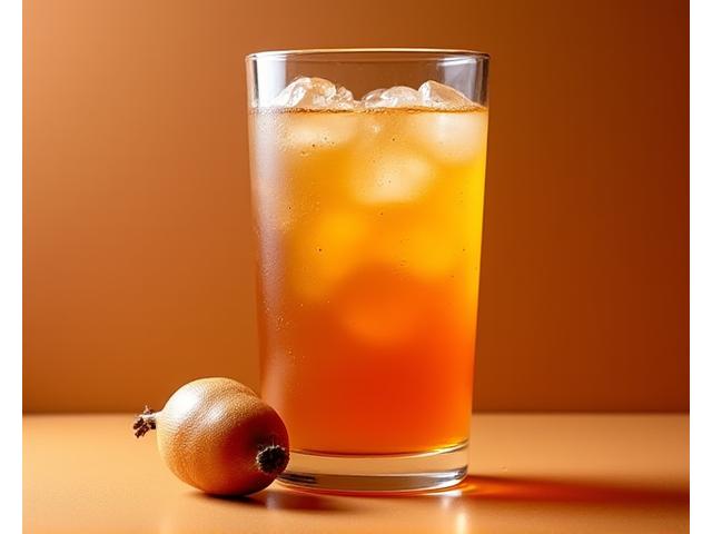 Amber-brown tamarindo drink with pulp visible in a clear glass